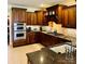 Well-equipped kitchen featuring tile backsplash, granite countertops, and stainless appliances at 107 Cedar Lake Dr, Statesville, NC 28625