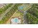 Scenic aerial view of a community pool, playground and tennis courts surrounded by lush landscaping at 11304 Preservation Ln, Charlotte, NC 28278