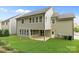 Back of house featuring siding, windows, and a walkout basement patio at 11304 Preservation Ln, Charlotte, NC 28278