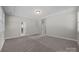 Carpeted bedroom with tray ceilings, recessed lighting, and large windows for natural light at 11304 Preservation Ln, Charlotte, NC 28278
