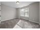 Cozy bedroom with neutral carpet, natural light and a window view at 11304 Preservation Ln, Charlotte, NC 28278