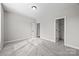 Cozy bedroom boasts soft carpet, neutral walls, and access to both a closet and the next room at 11304 Preservation Ln, Charlotte, NC 28278