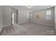 Spacious carpeted bedroom with tray ceilings, recessed lighting, and large windows for natural light at 11304 Preservation Ln, Charlotte, NC 28278