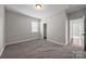 Neutral bedroom offers neutral carpet, baseboard trim, and a window with blinds at 11304 Preservation Ln, Charlotte, NC 28278