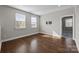 Light-filled bonus room with hardwood floors and two windows offering a scenic view of the outdoors at 11304 Preservation Ln, Charlotte, NC 28278