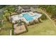 Overhead shot of a community pool and playground surrounded by lush landscaping and ample seating areas at 11304 Preservation Ln, Charlotte, NC 28278