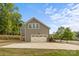 This charming home offers an attached garage and a well manicured lawn on a sunny day at 11304 Preservation Ln, Charlotte, NC 28278
