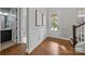 Elegant foyer with hardwood floors, wainscoting, and staircase at 11304 Preservation Ln, Charlotte, NC 28278