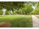 Lush green lawn with mature trees and sidewalk at 11304 Preservation Ln, Charlotte, NC 28278
