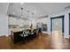 Spacious kitchen featuring a large island with seating, stainless steel appliances, and hardwood flooring at 11304 Preservation Ln, Charlotte, NC 28278