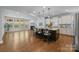 Open-concept kitchen and living area with a central island, fireplace, and an abundance of natural light at 11304 Preservation Ln, Charlotte, NC 28278