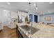 Bright kitchen with stainless steel appliances, a large island with a sink, and granite countertops at 11304 Preservation Ln, Charlotte, NC 28278