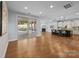 Spacious living room with a fireplace, hardwood floors, and access to an enclosed porch at 11304 Preservation Ln, Charlotte, NC 28278