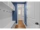 Mud room with white shelving, bench, and coat hooks, providing ample storage space at 11304 Preservation Ln, Charlotte, NC 28278