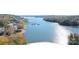 Scenic aerial view showcases the beautiful lake and a beach, with trees displaying vibrant fall colors at 120 N Cardinal N Dr, New London, NC 28127