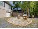 Backyard oasis featuring a fire pit, swing, and chairs for relaxation, complemented by lush landscaping and a garage at 120 N Cardinal N Dr, New London, NC 28127