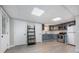 Finished basement kitchen features stainless appliances, grey cabinets, and durable grey flooring at 120 N Cardinal N Dr, New London, NC 28127