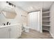 Bathroom featuring a vanity, modern fixtures, shower with curtain, tile floor, and built-in shelving at 120 N Cardinal N Dr, New London, NC 28127