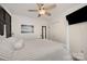 Modern bedroom with a four-poster bed, ceiling fan, closet, and beach-themed decor at 120 N Cardinal N Dr, New London, NC 28127