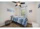 Bedroom features a twin-sized bed, ceiling fan, and window with blinds at 120 N Cardinal N Dr, New London, NC 28127