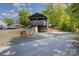 The house has a two-story porch, outdoor seating, and a gravel driveway at 120 N Cardinal N Dr, New London, NC 28127