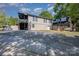 Exterior of the house featuring a large deck with stairs, a covered patio, a gravel parking area and a firepit at 120 N Cardinal N Dr, New London, NC 28127