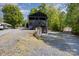 The home has a spacious lot with a two-story porch and driveway at 120 N Cardinal N Dr, New London, NC 28127