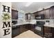 A charming kitchen features dark cabinets, appliances, and tile backsplash at 120 N Cardinal N Dr, New London, NC 28127