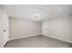 An expansive room showcases neutral walls, modern lighting, and grey wood floors, offering versatile living space at 120 N Cardinal N Dr, New London, NC 28127