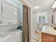 Bathroom featuring a washer/dryer, shower with curtain, and vanity with wood cabinets at 1278 Island Creek Dr, Troy, NC 27371