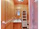 Small wood paneled bathroom with pink shower and fixtures, sink, and small storage at 1278 Island Creek Dr, Troy, NC 27371