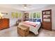Bright bedroom featuring light-colored walls and floors, ceiling fan, and multiple windows at 1278 Island Creek Dr, Troy, NC 27371
