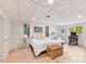 Spacious bedroom with wood flooring, windows, desk and chair, and modern decor at 1278 Island Creek Dr, Troy, NC 27371