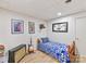 Small bedroom with wood flooring, white walls, and blue and white comforter at 1278 Island Creek Dr, Troy, NC 27371