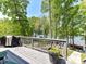 Wooden deck overlooking the lake with room for a grill and seating at 1278 Island Creek Dr, Troy, NC 27371