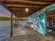 Covered waterfront dock with mural, seating, and storage, perfect for relaxing by the lake at 1278 Island Creek Dr, Troy, NC 27371