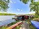 Waterfront dock with covered boat storage, featuring colorful artwork and easy access to the lake at 1278 Island Creek Dr, Troy, NC 27371
