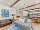 Open-concept living area with exposed beams, modern decor, and seamless flow to the kitchen at 1278 Island Creek Dr, Troy, NC 27371