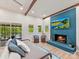 Inviting living room with blue brick fireplace, large windows, and comfortable decor at 1278 Island Creek Dr, Troy, NC 27371