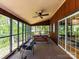 Screened in porch with seating, picnic table, ceiling fan, and lake view at 1278 Island Creek Dr, Troy, NC 27371