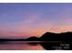 Scenic sunset view over the lake, casting a serene twilight glow on the water and distant hills at 1278 Island Creek Dr, Troy, NC 27371