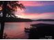 Serene sunset view over the lake, showcasing the dock and tranquil waterfront living at 1278 Island Creek Dr, Troy, NC 27371