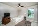 Bedroom with cozy decor, ceiling fan, and large window overlooking water at 129 Morrison Cove Rd, Mooresville, NC 28117