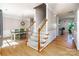 Home entryway featuring staircase with wood banister and adjacent dining area at 129 Morrison Cove Rd, Mooresville, NC 28117