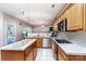 Well-lit kitchen with wood cabinets, stainless steel appliances, and an open layout to the living area at 129 Morrison Cove Rd, Mooresville, NC 28117