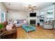 Inviting living room with hardwood floors, fireplace, and built-in shelving at 129 Morrison Cove Rd, Mooresville, NC 28117