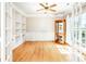 Bright and airy office space featuring hardwood floors, built-in shelves, and French doors at 129 Morrison Cove Rd, Mooresville, NC 28117