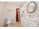 Bright bathroom with white vanity, decorative mirror, toilet and access to walk in closet at 1376 Garland Ln, Lincolnton, NC 28092