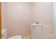 Small bathroom with a white vanity, toilet, and neutral wall color at 1376 Garland Ln, Lincolnton, NC 28092