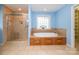 A full bathroom featuring a walk-in shower, a large tub, and a large window at 1376 Garland Ln, Lincolnton, NC 28092